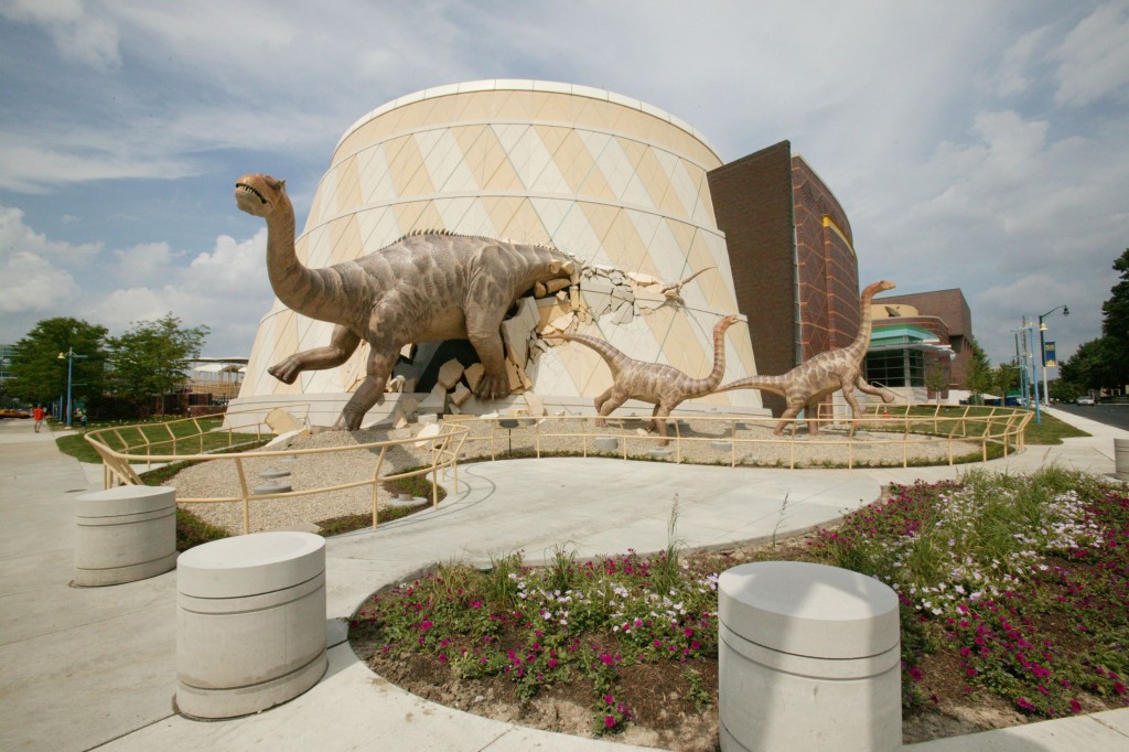 mother alamosaurus and two babies breaking out of The Children's Museum of Indianapolis