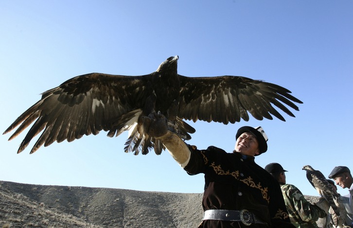 A hunter releases golden eagle in the village of Bokonbayevo, south-east of Bishkek